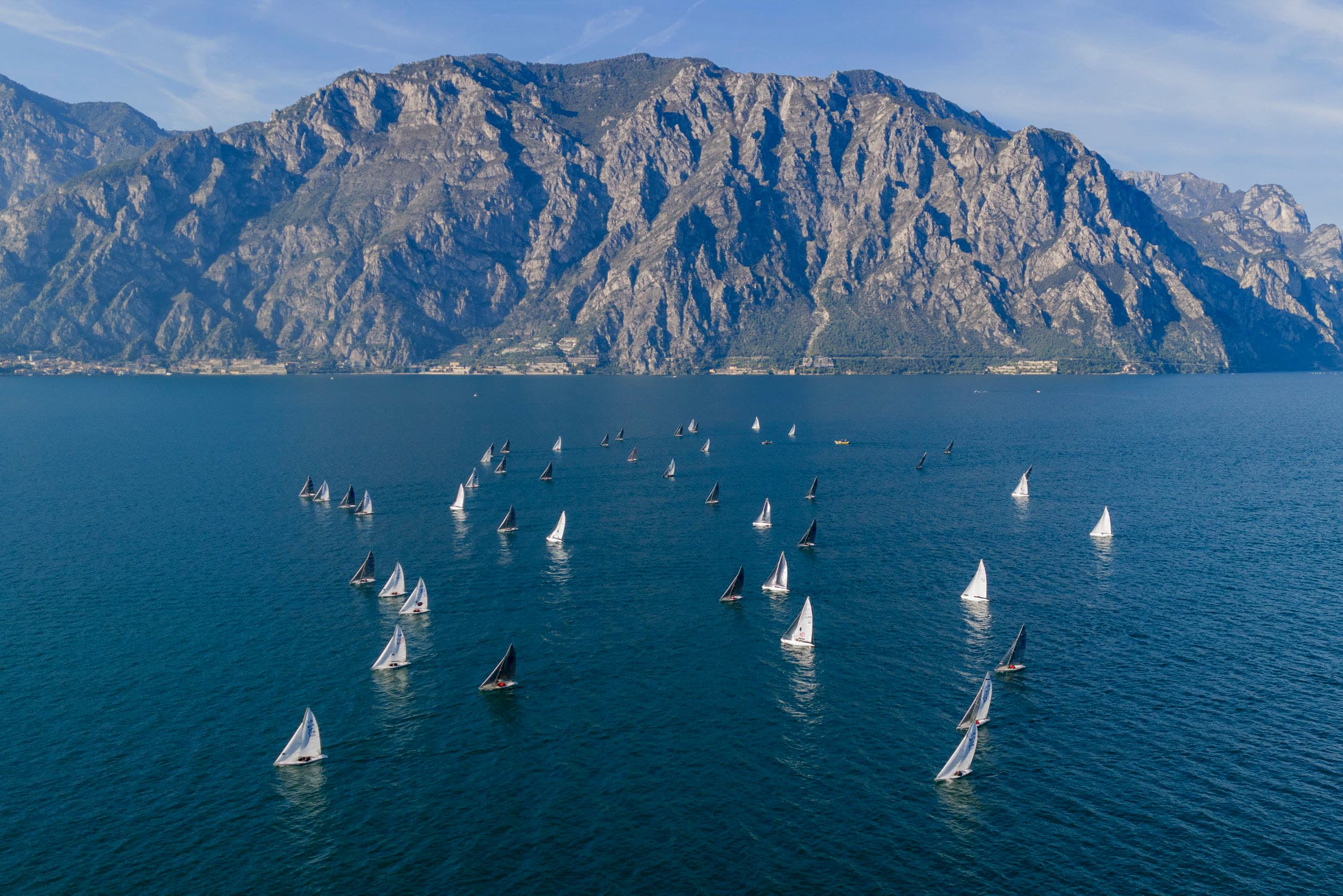 A 2.4mR fleet racing on a mountain lake, seen from above
